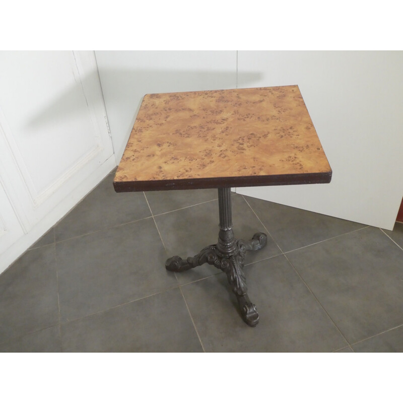 Vintage bistro table with caramel colored formica top with Mc Do logo