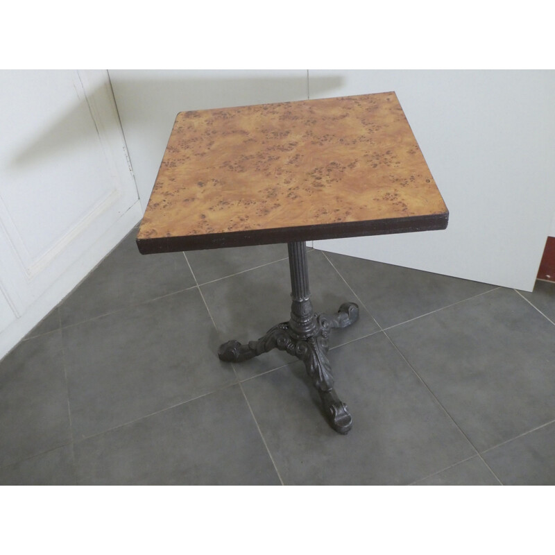 Vintage bistro table with caramel colored formica top with Mc Do logo