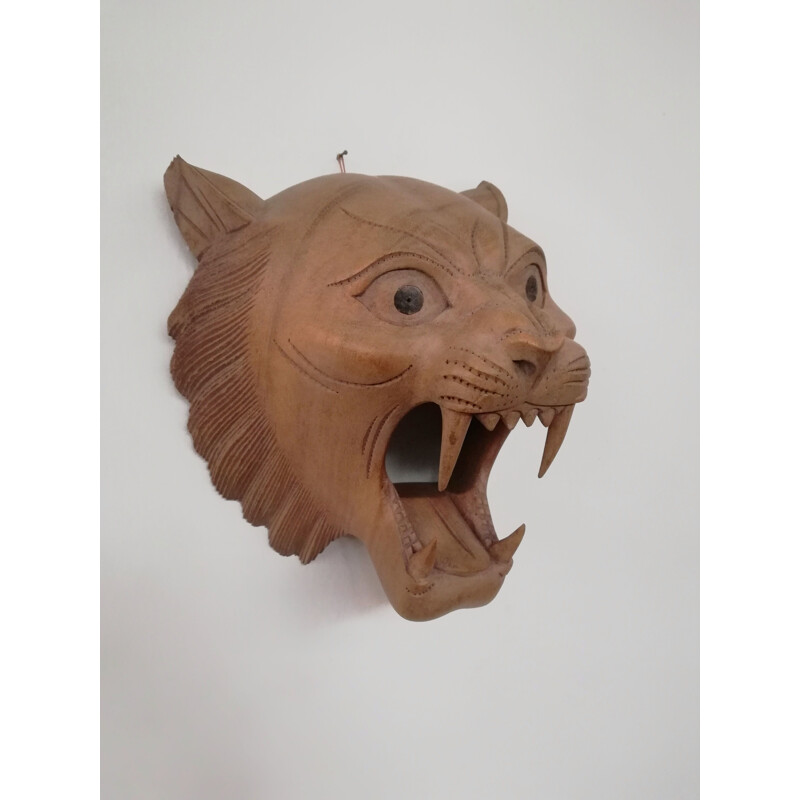 Vintage carved wooden mask representing a roaring tiger