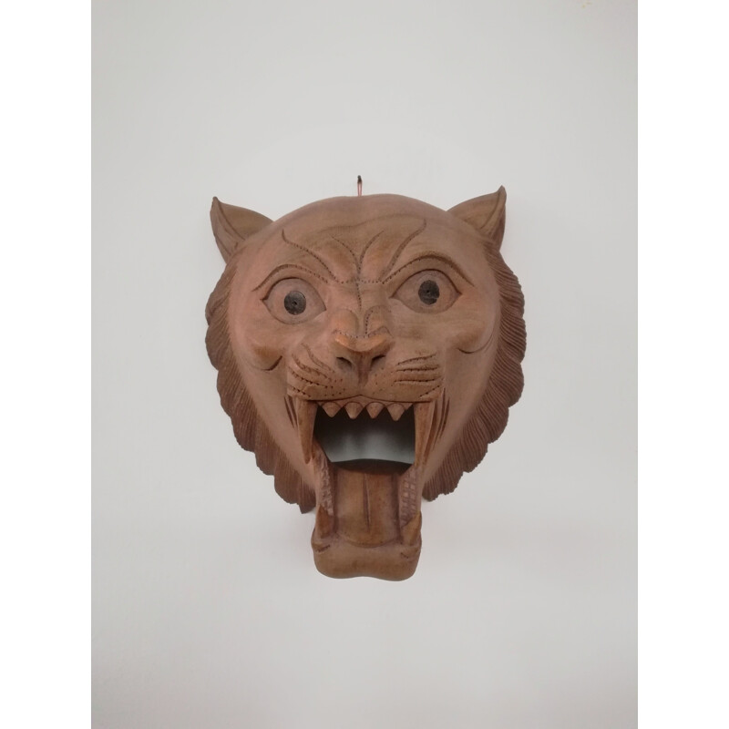 Vintage carved wooden mask representing a roaring tiger