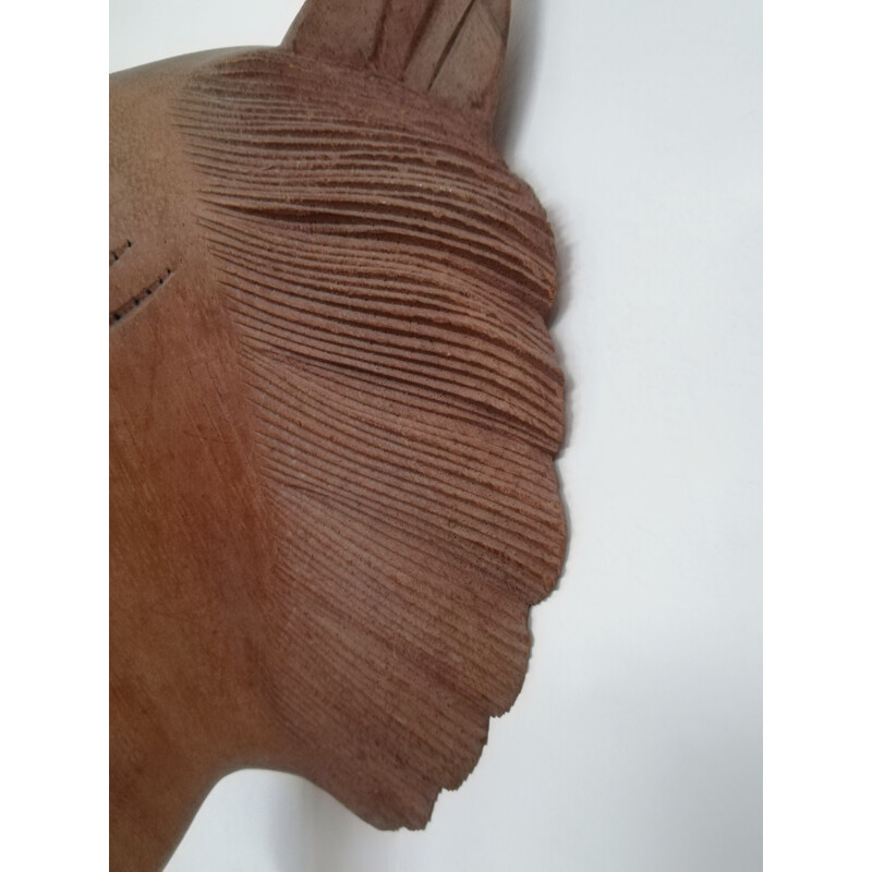 Vintage carved wooden mask representing a roaring tiger