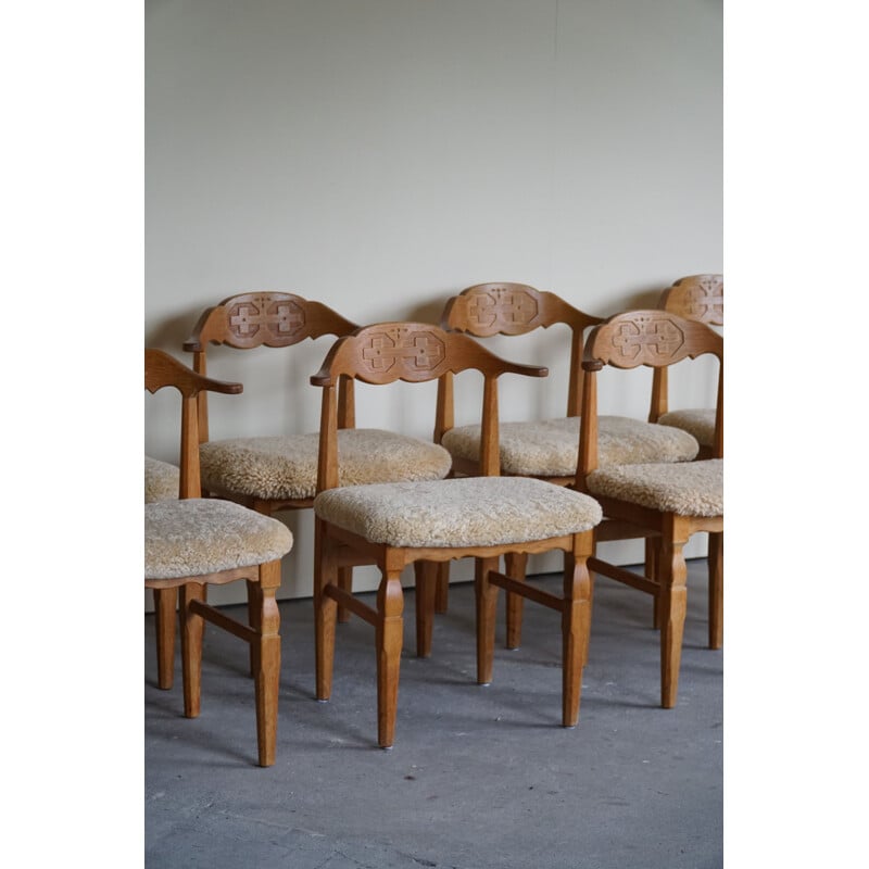 Set of 10 vintage dining chairs in oakwood and reupholstered in lambswool by Henning Kjærnulf, 1960s