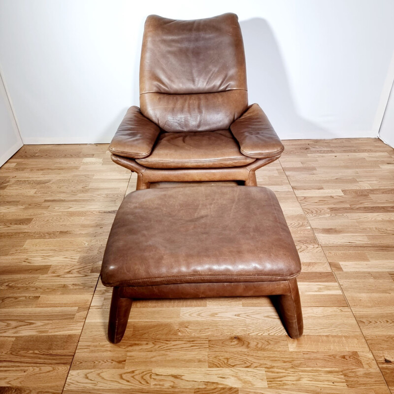 Vintage brown leather armchair and ottoman by Hans Kaufeld, 1970-1980