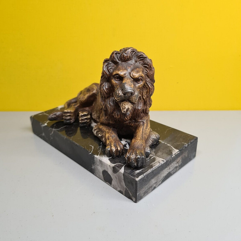 Vintage paperweight of a metal lion on a marble base