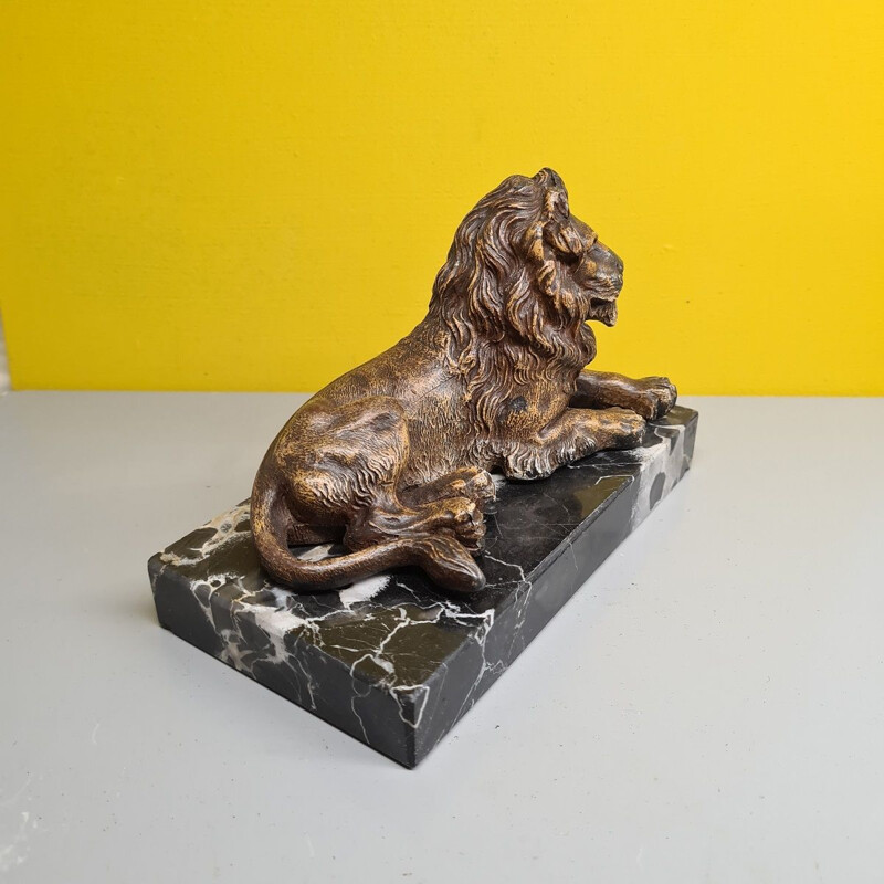 Vintage paperweight of a metal lion on a marble base