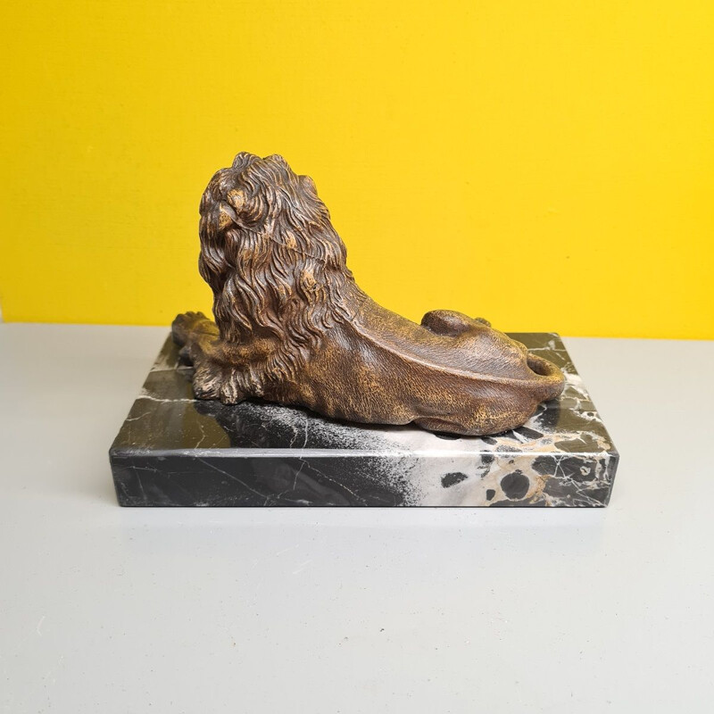 Vintage paperweight of a metal lion on a marble base