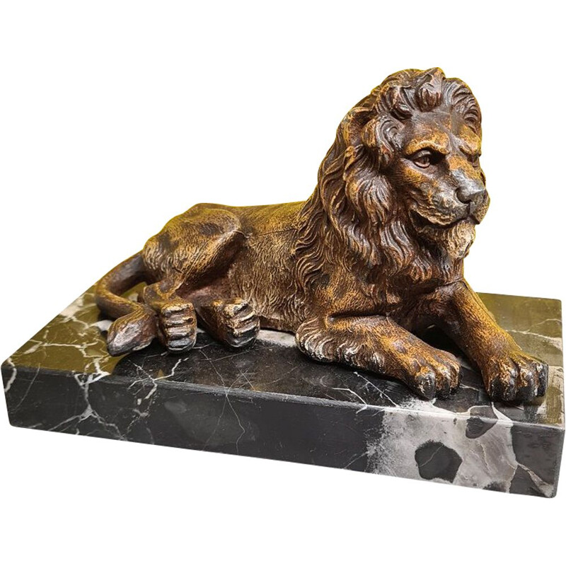 Vintage paperweight of a metal lion on a marble base