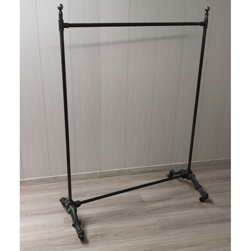 Vintage folding cast iron coat rack on wheels