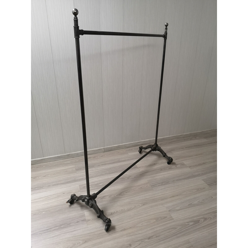 Vintage folding cast iron coat rack on wheels