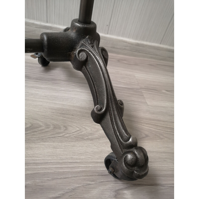 Vintage folding cast iron coat rack on wheels