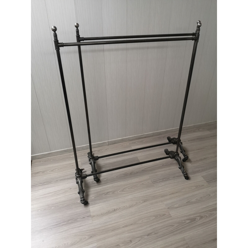 Vintage folding cast iron coat rack on wheels