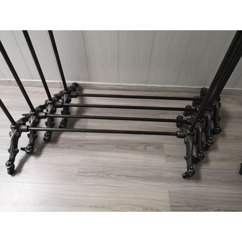 Vintage folding cast iron coat rack on wheels