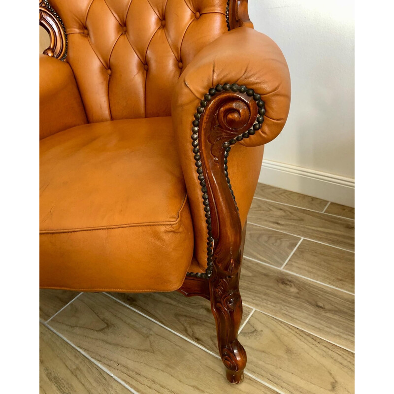 Vintage Chesterfield armchair in leather and carved wood