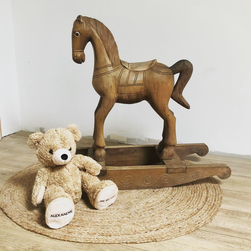 Vintage rocking horse in carved wood