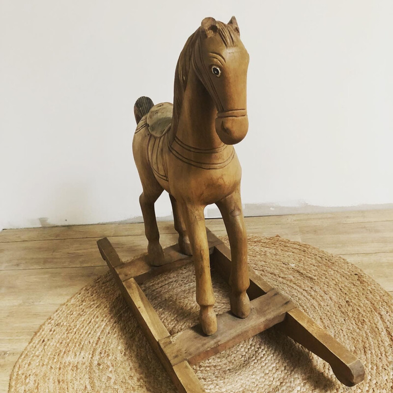 Vintage rocking horse in carved wood