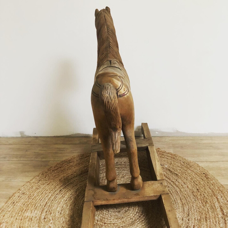 Vintage rocking horse in carved wood