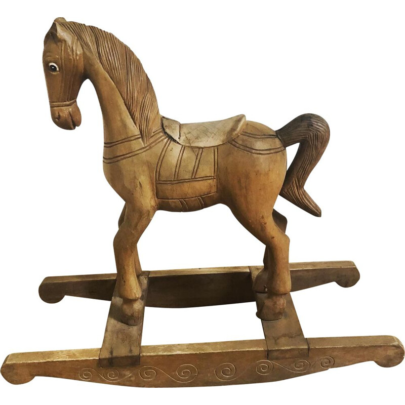 Vintage rocking horse in carved wood