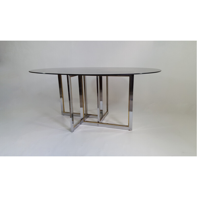 Oval dining table with asymmetrical feet - 1970s