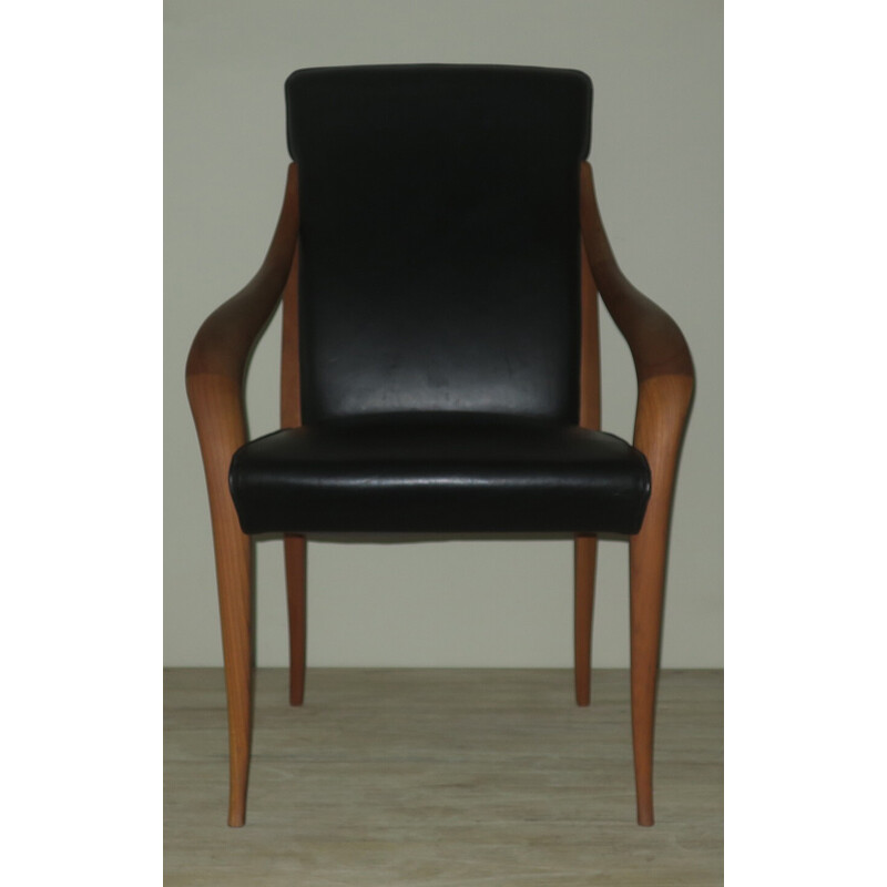 Vintage black leather armchair with curved arms