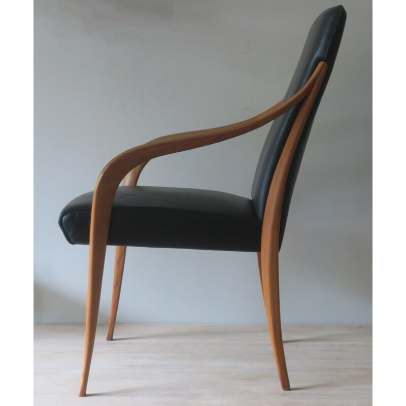 Vintage black leather armchair with curved arms