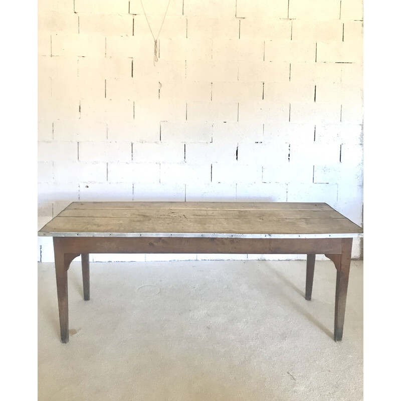 Vintage farm table surrounded by zinc on the sides