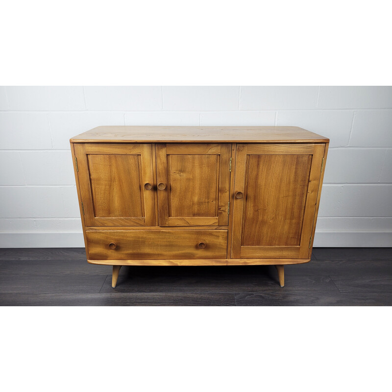 Vintage solid English elm sideboard with flared leg by Ercol, England 1960