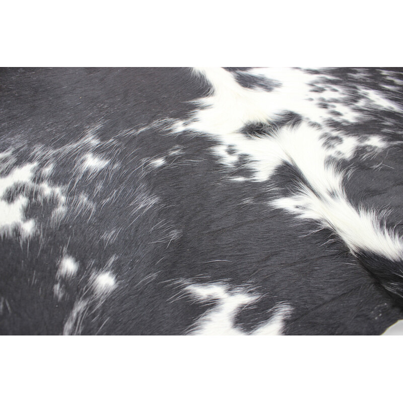 Vintage black and white cowhide rug