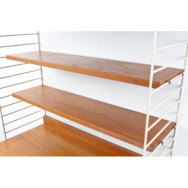 Modular wall system in teak and metal with several shelves by Nils Strinning for AB String - 1950s