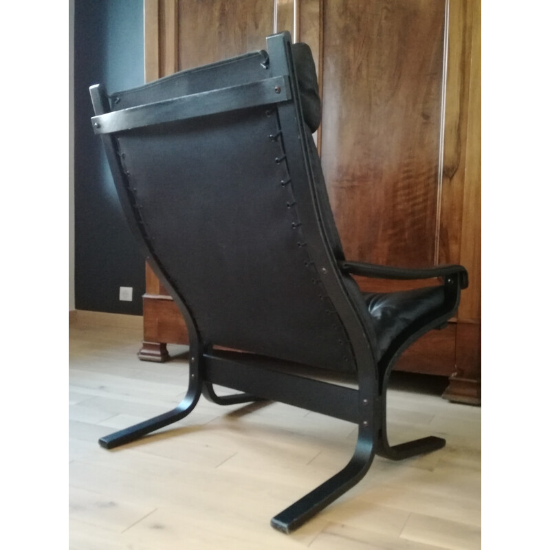 Scandinavian armchair in black leather and ottoman Ingmar Relling - 1970s