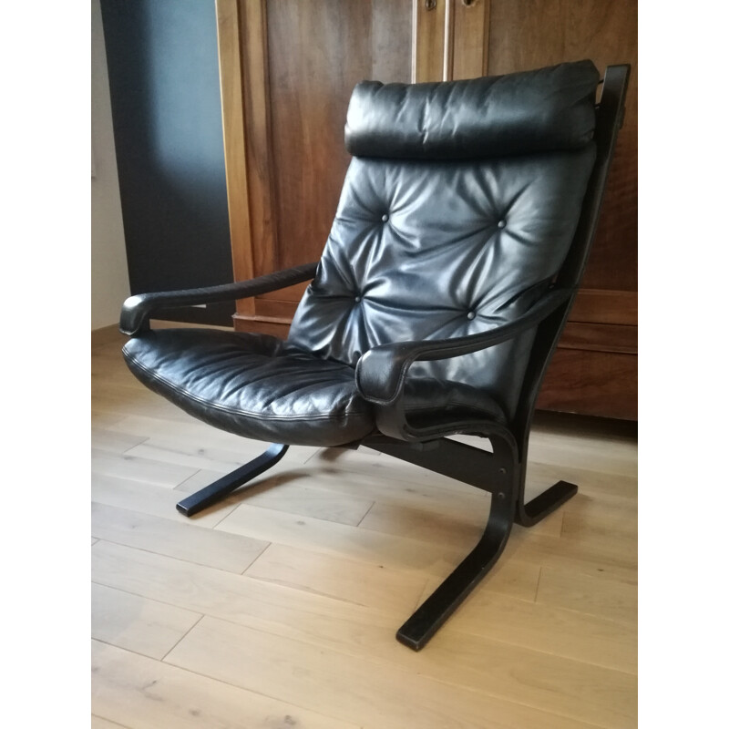 Scandinavian armchair in black leather and ottoman Ingmar Relling - 1970s