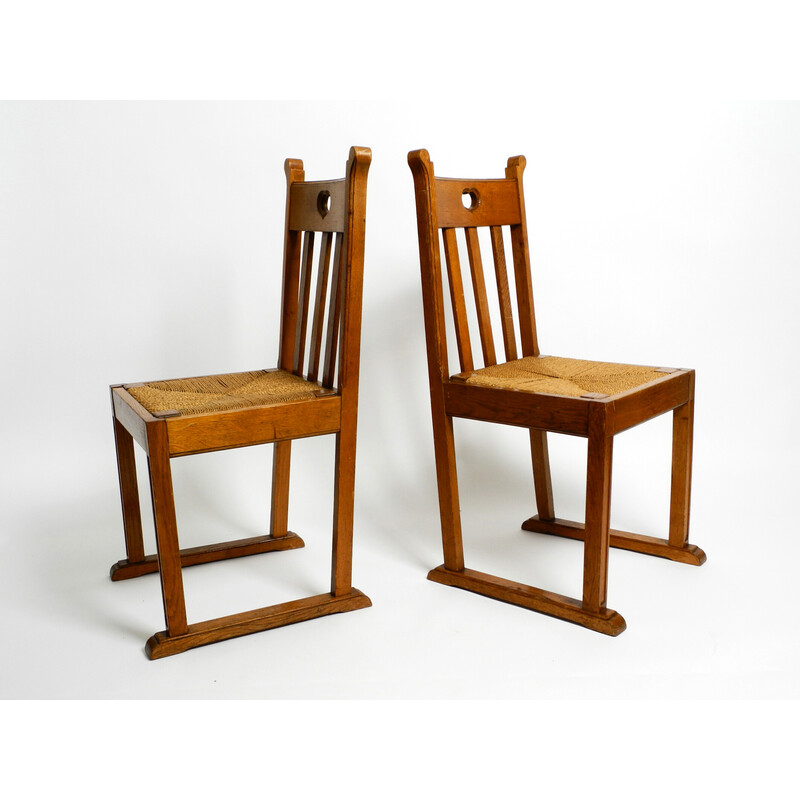 Paar vintage eikenhouten stoelen met sledepoten en rieten zittingen