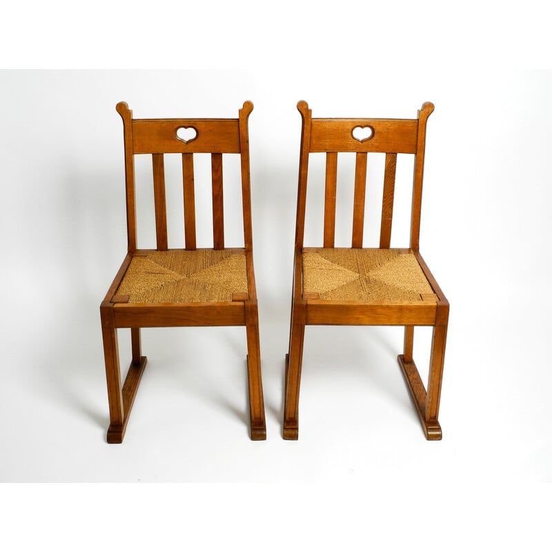 Pair of vintage oakwood chairs with skid feet and wicker seats