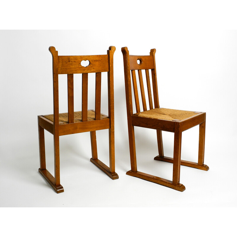Par de cadeiras de madeira de carvalho vintage com pés de derrapagem e assentos de vime