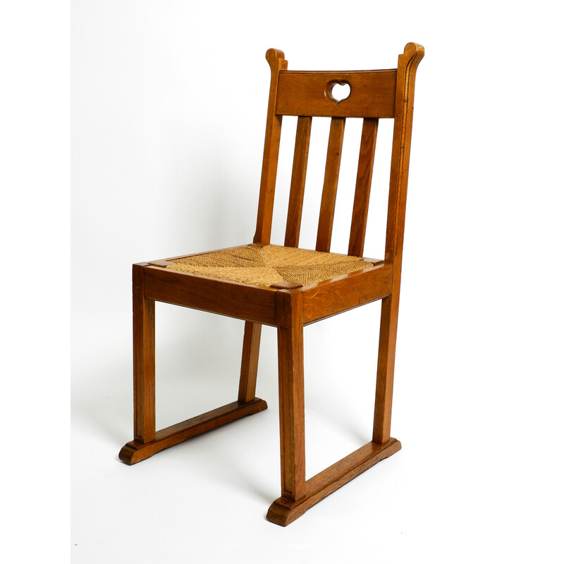 Pareja de sillas vintage de madera de roble con patas deslizantes y asientos de mimbre