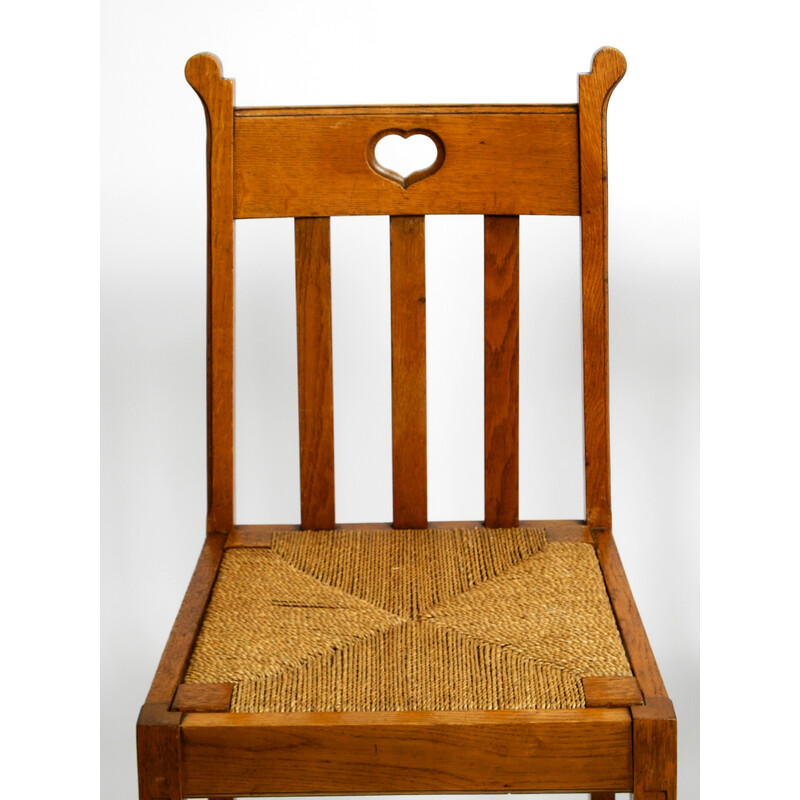 Paire de chaises vintage en chêne avec pieds patins et sièges en osier