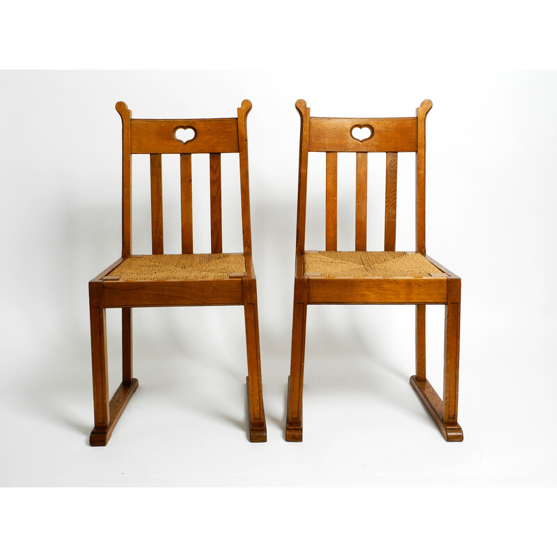 Pair of vintage oakwood chairs with skid feet and wicker seats