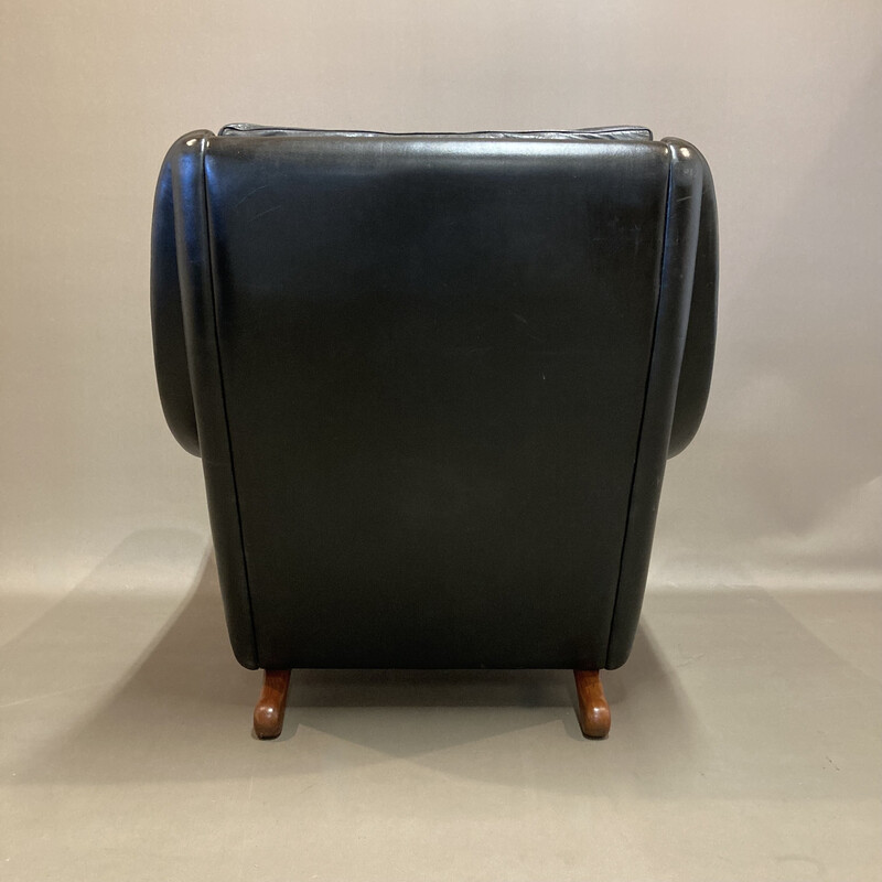 Scandinavian vintage armchair in black leather and teak by Aage Christiansen, 1950