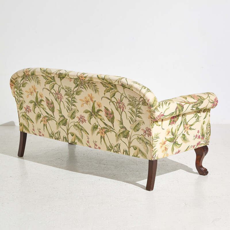 Vintage two-seater sofa with textile upholstery and mahogany legs