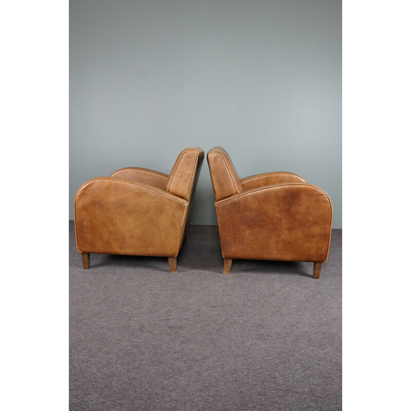 Pair of vintage cowhide leather armchairs