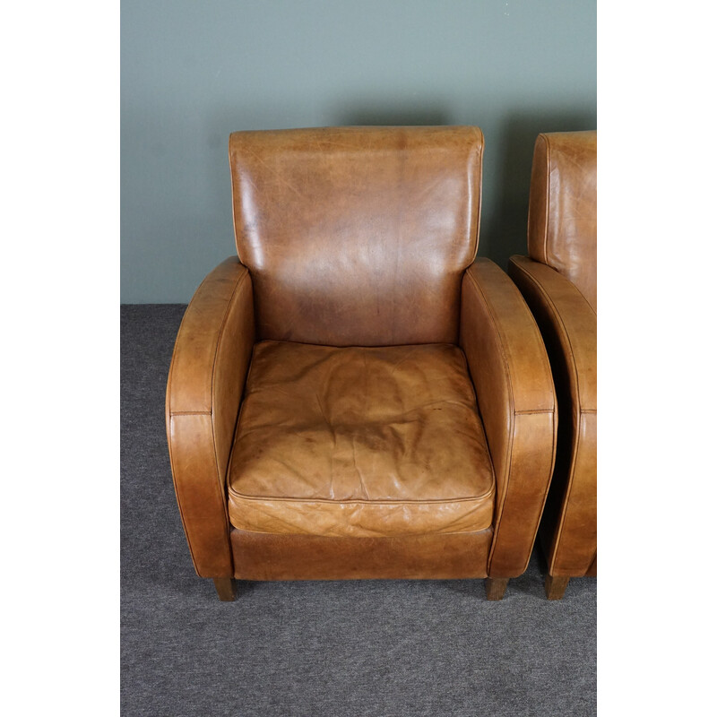 Pair of vintage cowhide leather armchairs