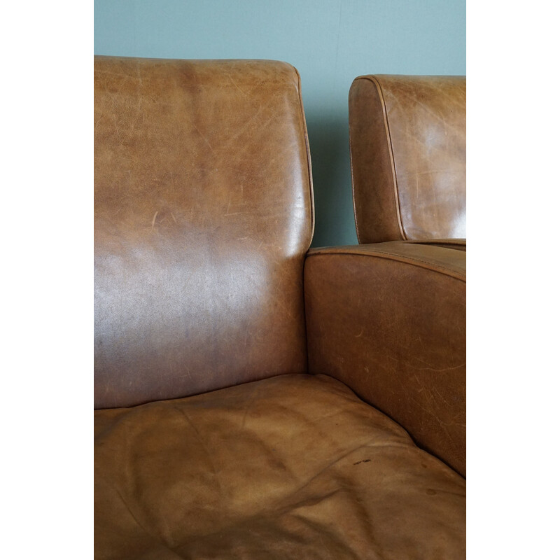 Pair of vintage cowhide leather armchairs