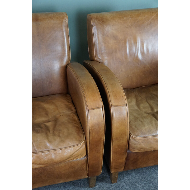 Pair of vintage cowhide leather armchairs