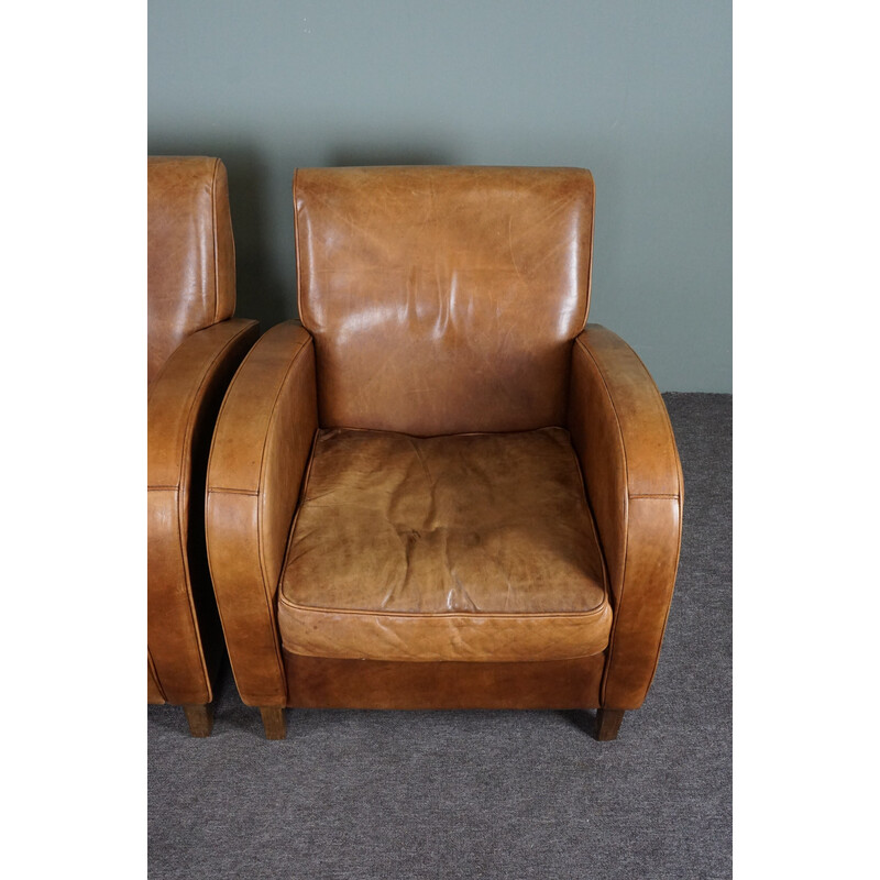 Pair of vintage cowhide leather armchairs