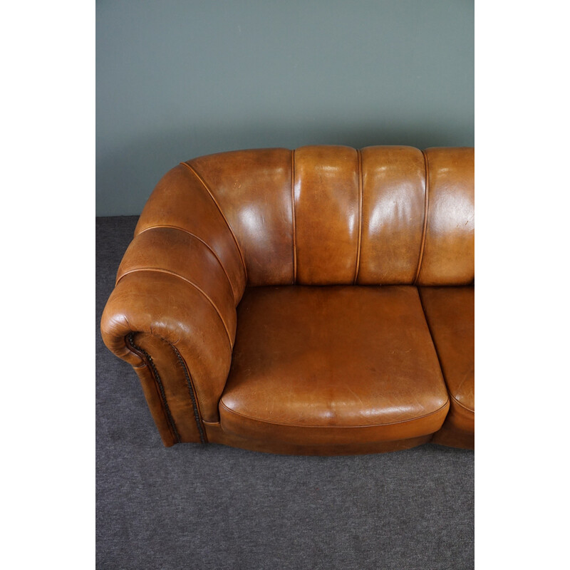 Vintage sheep leather sofa finished with decorative nails