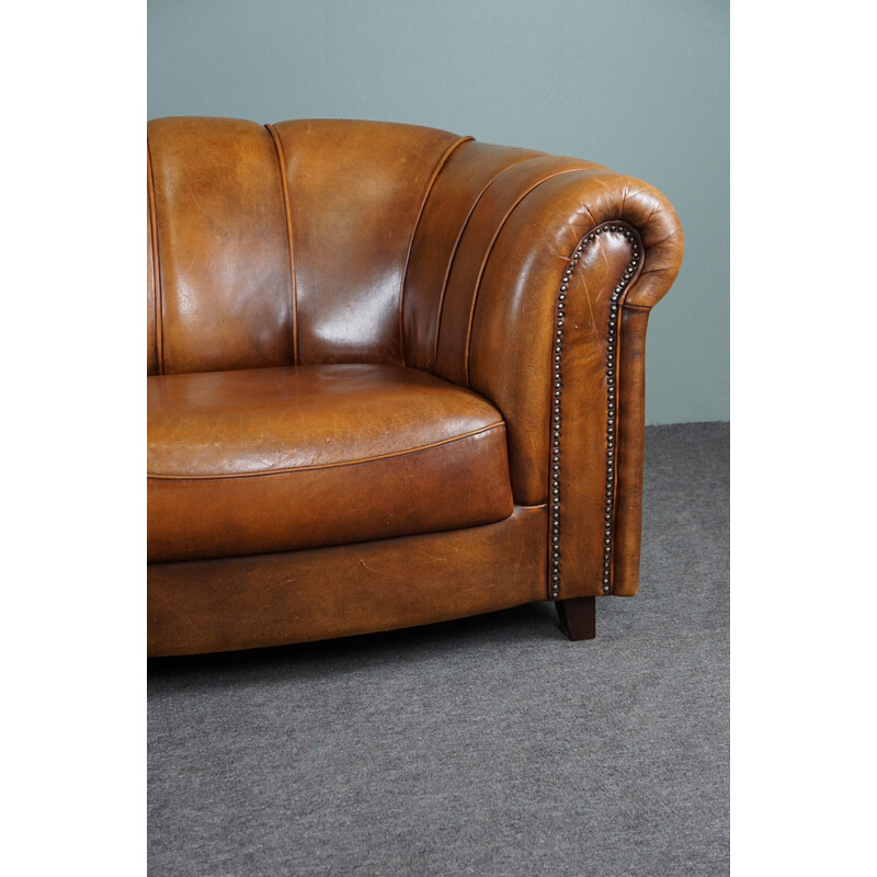 Vintage sheep leather sofa finished with decorative nails
