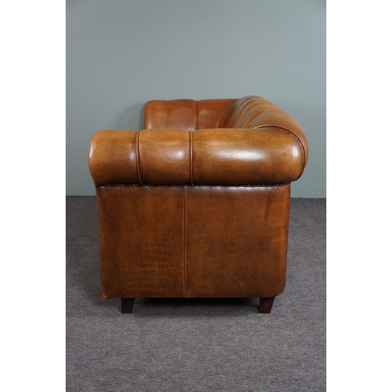 Vintage sheep leather sofa finished with decorative nails