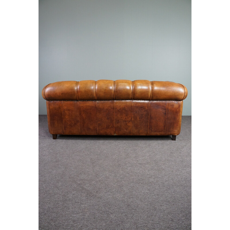 Vintage sheep leather sofa finished with decorative nails