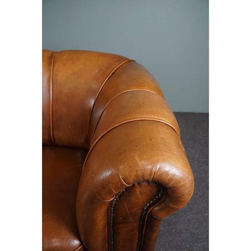 Vintage sheep leather sofa finished with decorative nails