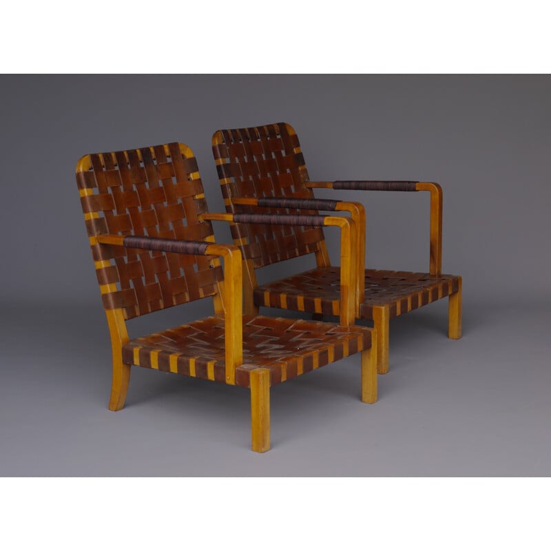 Pair of mid-century French armchairs in walnut and leather, 1950s