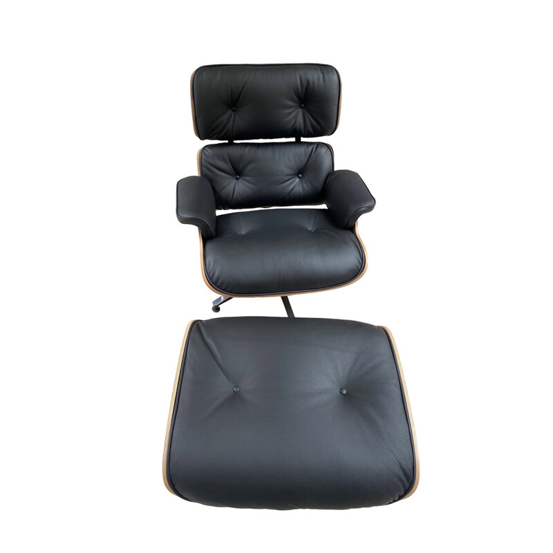 Vintage armchair and ottoman in grained leather and rosewood by Eames for Herman Miller, USA 2009